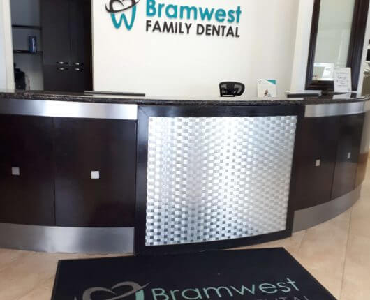 reception area with the bramwest dental logo on the wall